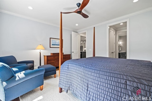 carpeted bedroom featuring crown molding, ceiling fan, and ensuite bath