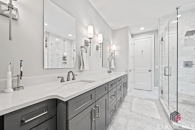 bathroom with vanity and a shower with shower door