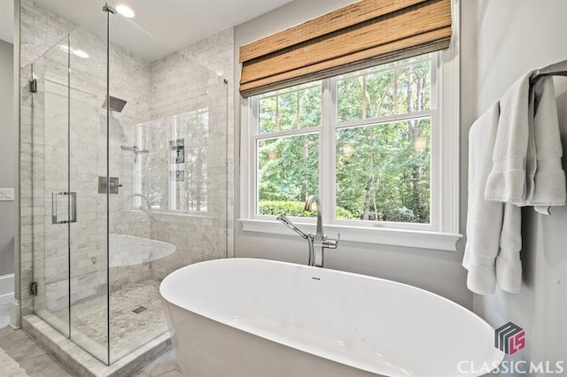 bathroom featuring separate shower and tub