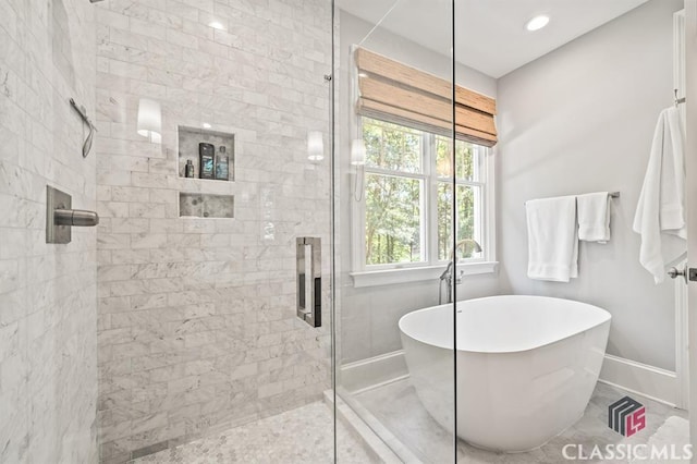 bathroom featuring shower with separate bathtub