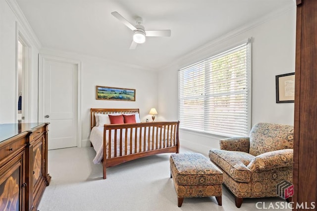 bedroom featuring crown molding, light colored carpet, and ceiling fan