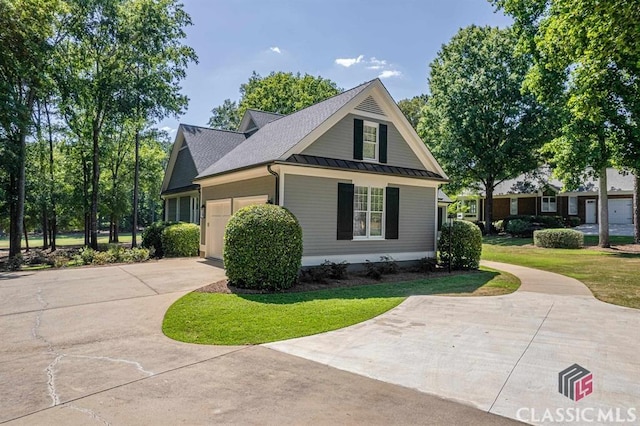 view of side of property with a garage and a yard