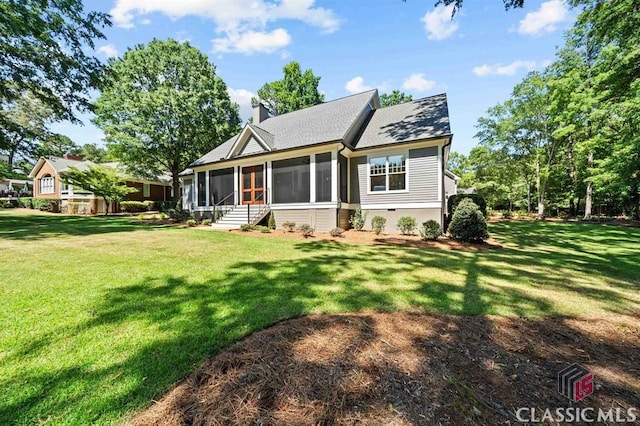 view of front facade with a sunroom and a front lawn