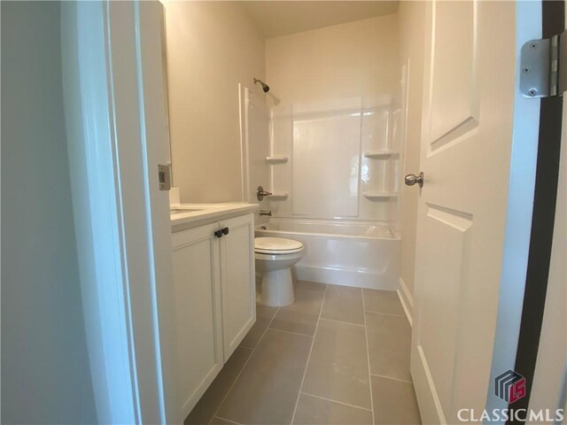 216 Montview Dr, Jefferson, GA 30549 - bathroom with tile patterned floors, toilet, vanity, tub / shower combination, and baseboards