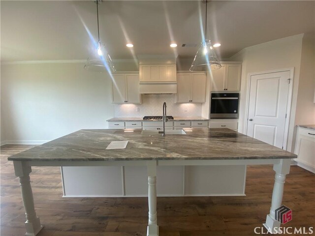 216 Montview Dr, Jefferson, GA 30549 - kitchen featuring wall oven, white cabinets, dark stone counters, ornamental molding, and recessed lighting