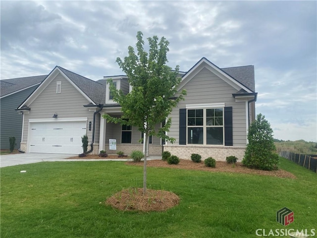 216 Montview Dr, Jefferson, GA 30549 - view of front of home with concrete driveway, an attached garage, and stone siding