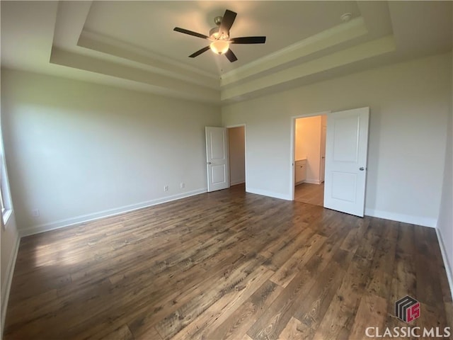 216 Montview Dr, Jefferson, GA 30549 - unfurnished bedroom featuring a raised ceiling, dark wood-style flooring, and baseboards