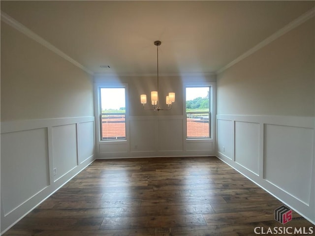 216 Montview Dr, Jefferson, GA 30549 - unfurnished dining area with a chandelier, a decorative wall, dark wood finished floors, a wainscoted wall, and crown molding