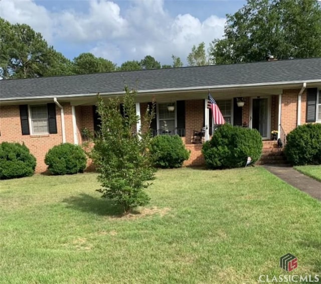 single story home with brick siding, roof with shingles, and a front yard