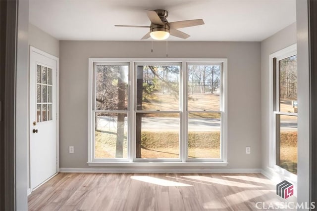 doorway featuring light hardwood / wood-style floors and ceiling fan