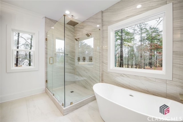 bathroom featuring separate shower and tub and a wealth of natural light