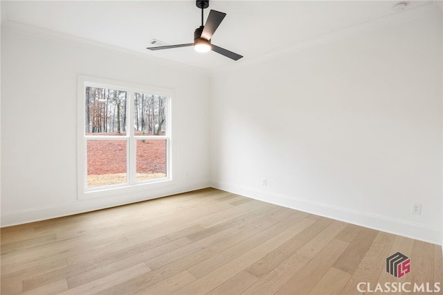 empty room featuring ceiling fan, light wood-type flooring, and crown molding