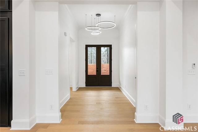 entrance foyer featuring light hardwood / wood-style floors and french doors