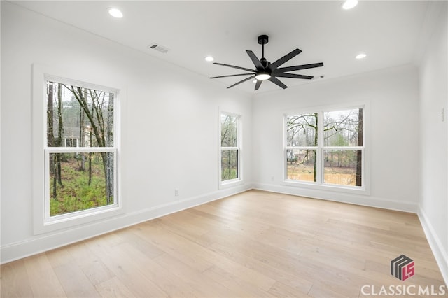 empty room featuring light wood-type flooring and ceiling fan