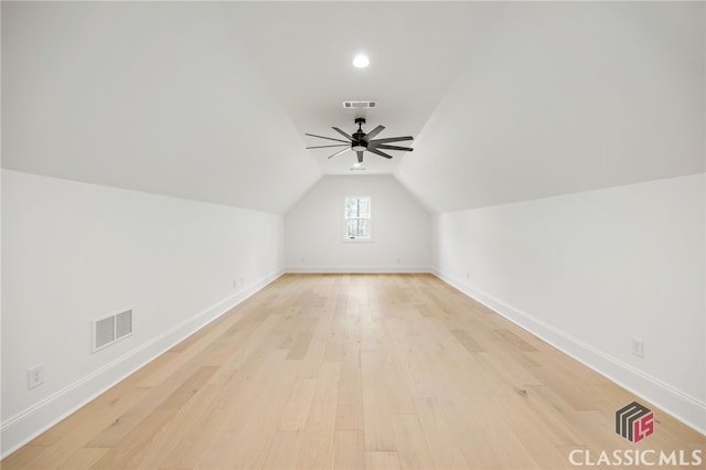 additional living space featuring light wood-type flooring, vaulted ceiling, and ceiling fan