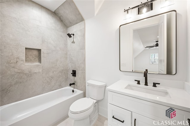 full bathroom featuring tiled shower / bath, toilet, ceiling fan, vaulted ceiling, and vanity