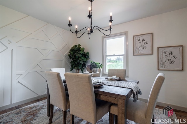 dining space featuring a notable chandelier and dark hardwood / wood-style floors