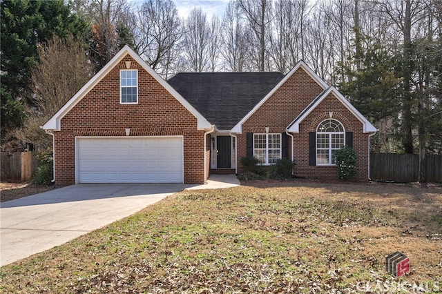 traditional home with driveway, a garage, fence, and brick siding