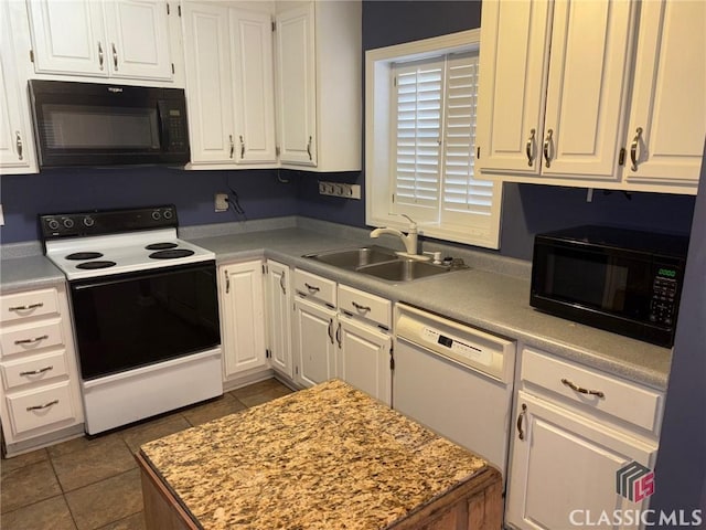 kitchen featuring sink, white cabinetry, dishwasher, electric range, and dark tile patterned flooring