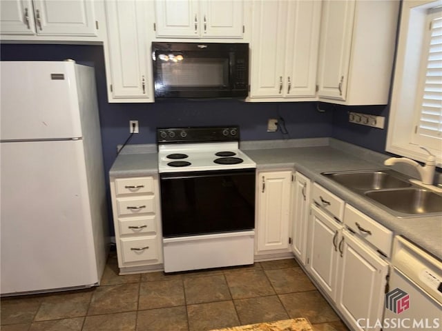 kitchen with white appliances, white cabinetry, and sink