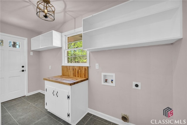 clothes washing area featuring hookup for a washing machine, baseboards, laundry area, and electric dryer hookup