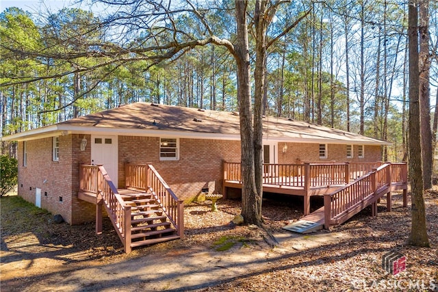 single story home featuring crawl space, a wooden deck, stairway, and brick siding