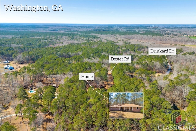 birds eye view of property with a view of trees