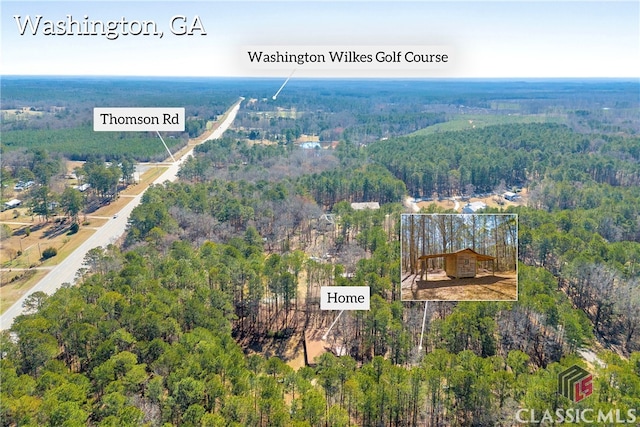 birds eye view of property featuring a view of trees