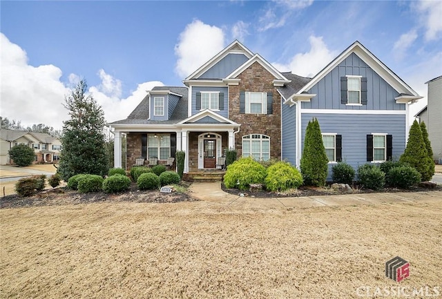 craftsman-style house with covered porch and a front yard