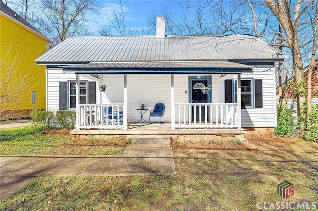 rear view of house featuring covered porch