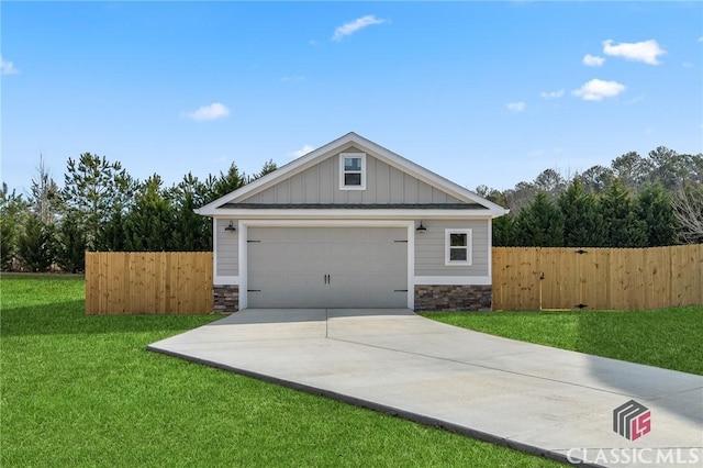 view of front of property with a garage, stone siding, board and batten siding, and fence