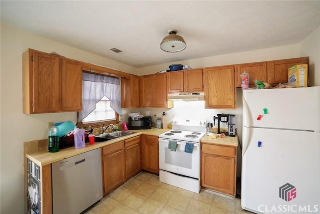 kitchen with sink and white appliances