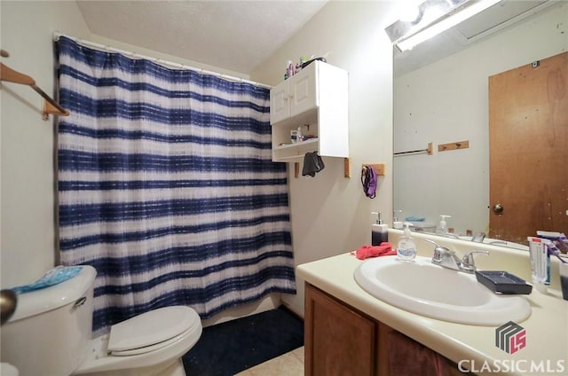 bathroom featuring vanity, a shower with shower curtain, and toilet