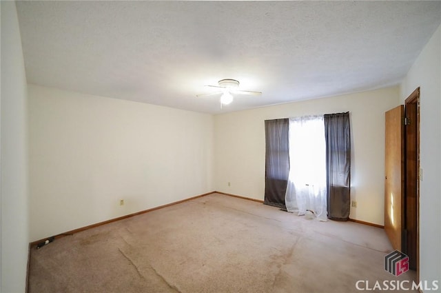 carpeted empty room with a textured ceiling