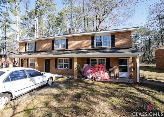 view of front of property with covered porch and a front yard