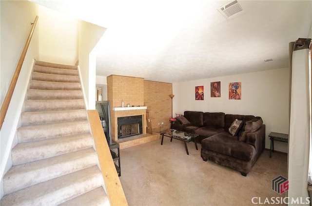 living room featuring a brick fireplace and carpet