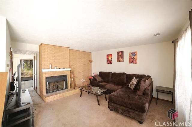 carpeted living room featuring a brick fireplace