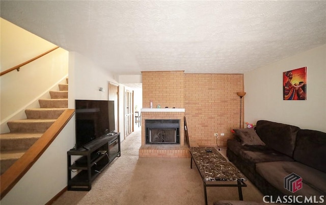 living room with a textured ceiling, carpet floors, and a fireplace