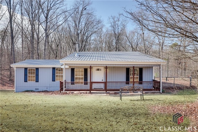 view of front of house with crawl space, covered porch, metal roof, and a front lawn