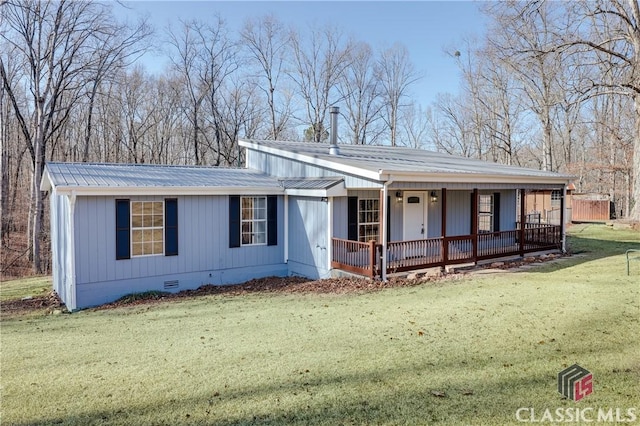 view of front of house with metal roof, a porch, crawl space, and a front yard