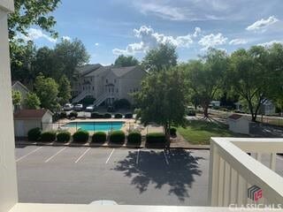 uncovered parking lot with an outdoor pool