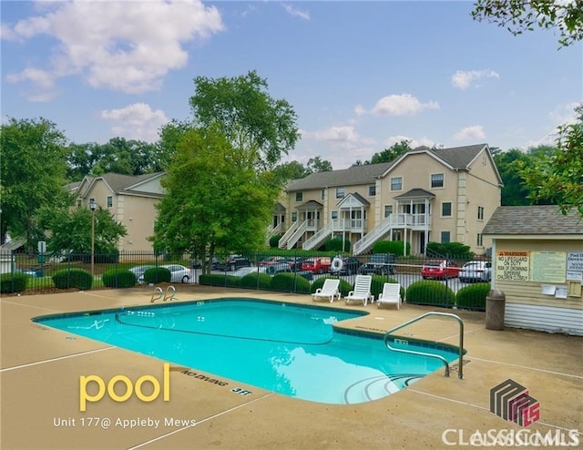 community pool featuring fence and a patio