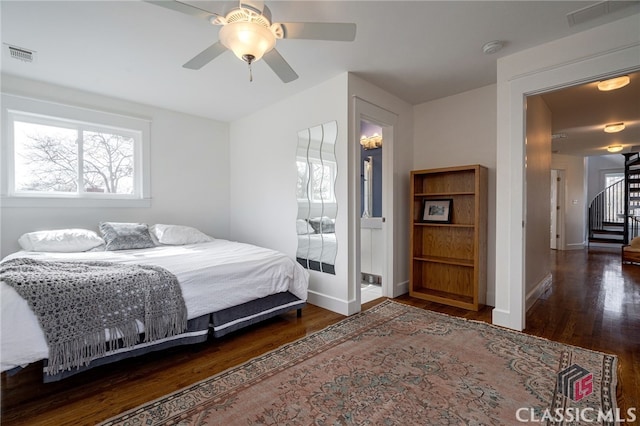 bedroom with dark wood-style floors, visible vents, and baseboards