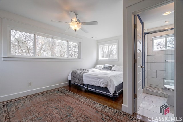 bedroom with a ceiling fan, baseboards, and wood finished floors