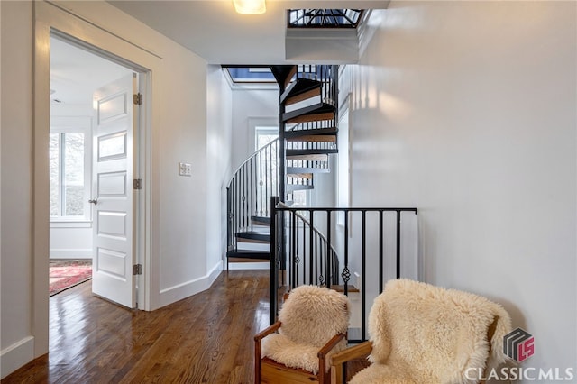 stairway featuring wood finished floors and baseboards