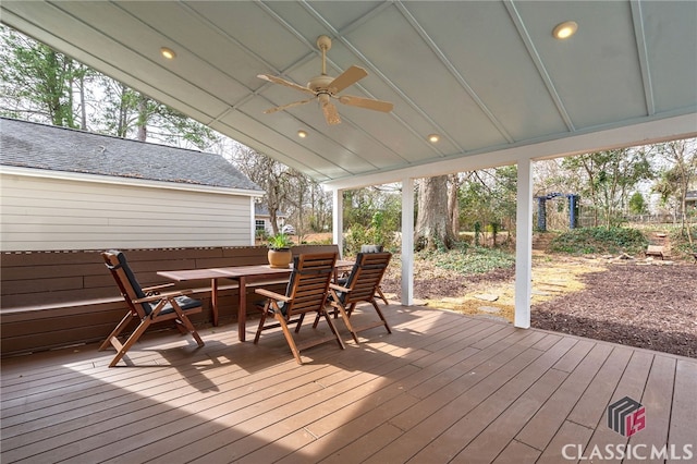 wooden deck featuring outdoor dining area and a ceiling fan