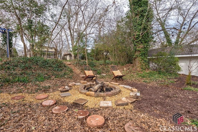 view of yard with a fire pit