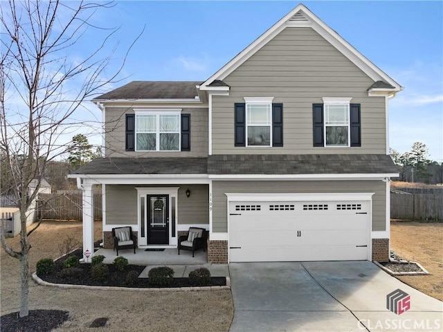 view of front of property with covered porch, a garage, brick siding, fence, and driveway