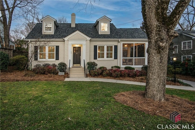 cape cod home featuring a front lawn, a chimney, and a shingled roof