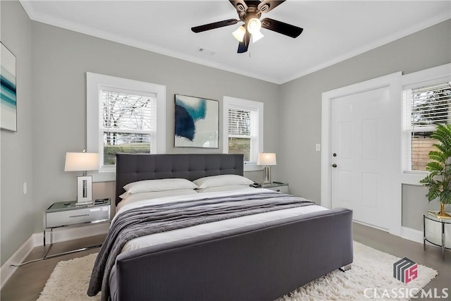 bedroom featuring ornamental molding, visible vents, and baseboards